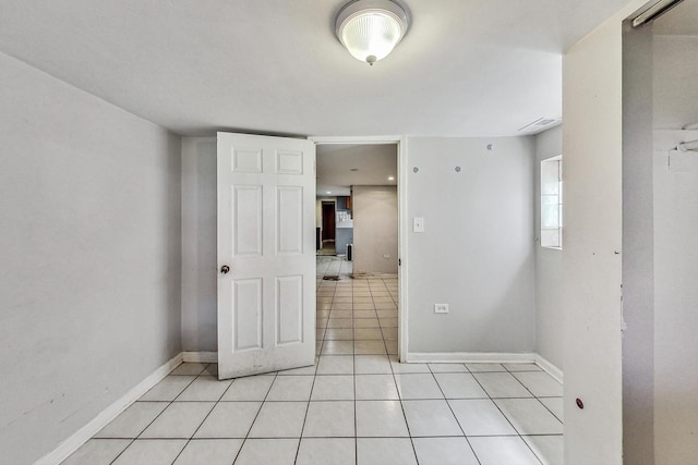 spare room featuring light tile patterned flooring