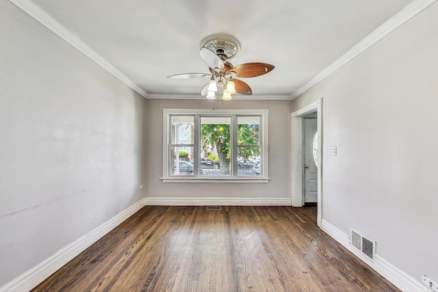 spare room with ceiling fan, crown molding, and dark wood-type flooring