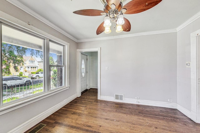 spare room with dark hardwood / wood-style floors, ceiling fan, and ornamental molding