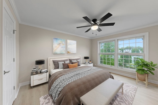 bedroom featuring ornamental molding, a ceiling fan, light wood-style flooring, and baseboards