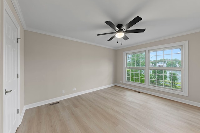 empty room with a ceiling fan, visible vents, baseboards, ornamental molding, and light wood-type flooring