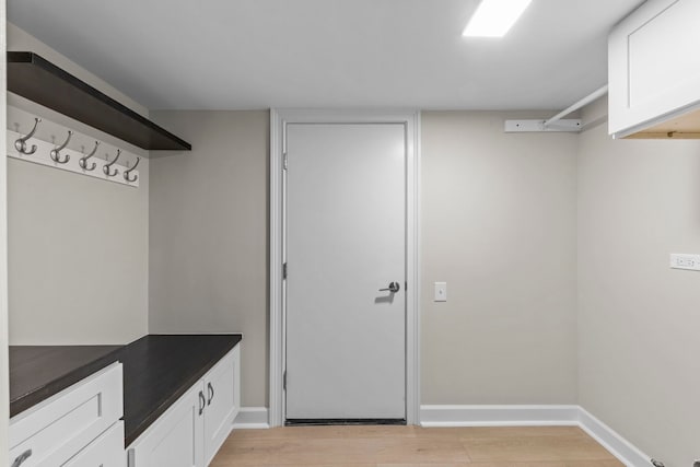 mudroom featuring light wood-style floors and baseboards