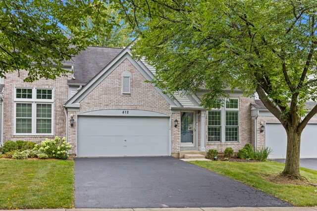 view of front of house featuring a garage and a front lawn