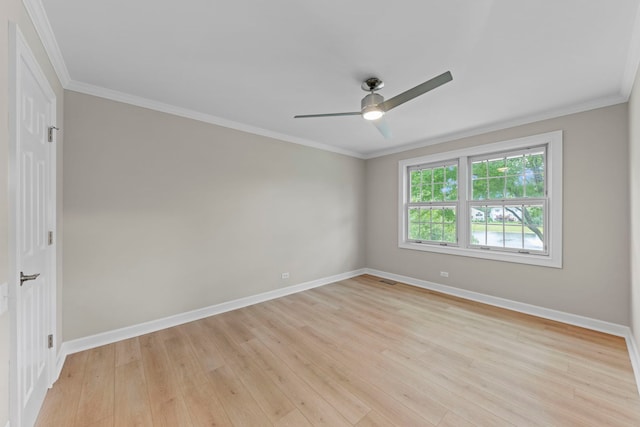 unfurnished room featuring baseboards, crown molding, and light wood finished floors