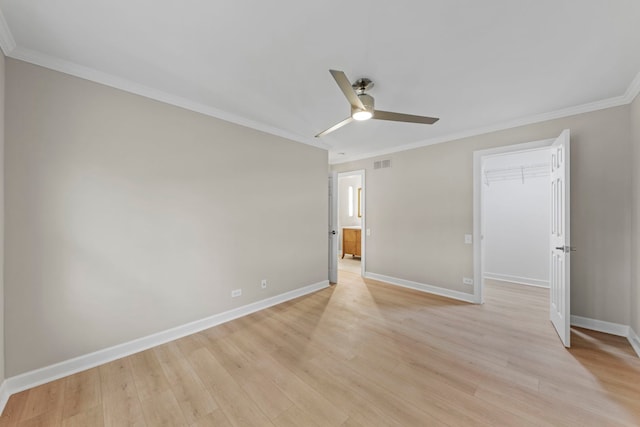 unfurnished bedroom with visible vents, crown molding, light wood-style flooring, and baseboards