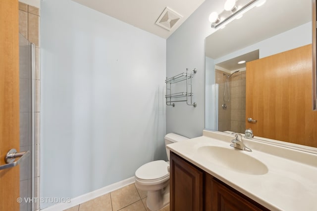 bathroom with tile flooring, toilet, and vanity