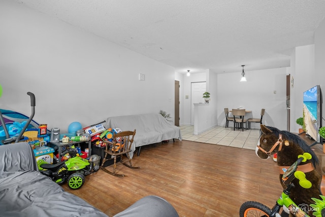 bedroom with a textured ceiling and light wood-type flooring