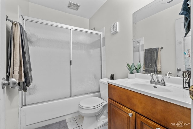 full bathroom featuring toilet, enclosed tub / shower combo, tile patterned flooring, and vanity