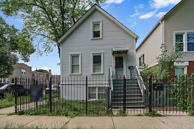 view of front of property with a fenced front yard and a gate