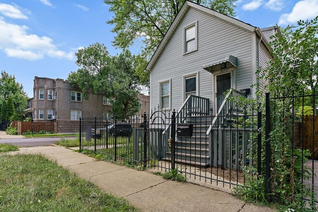 view of front of house featuring a fenced front yard and a gate