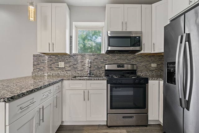 kitchen with white cabinetry, stainless steel appliances, and a sink