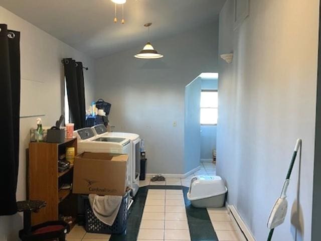 interior space with washer and dryer, a baseboard heating unit, and light tile patterned flooring