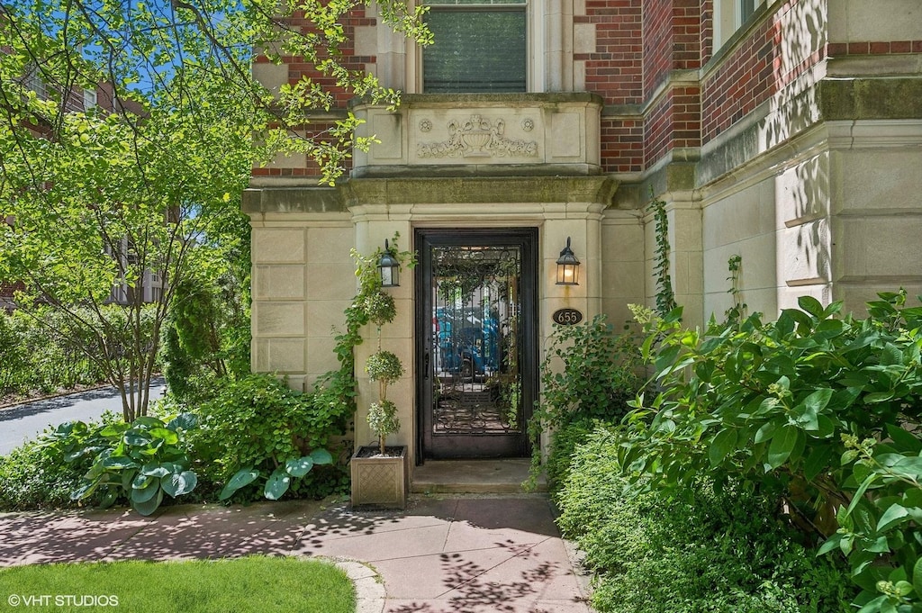 entrance to property with stone siding and brick siding