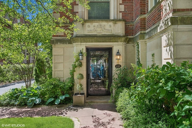 entrance to property with stone siding and brick siding