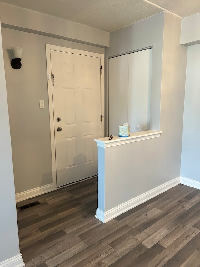 entryway with dark hardwood / wood-style floors