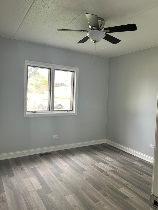 unfurnished room featuring hardwood / wood-style floors and ceiling fan