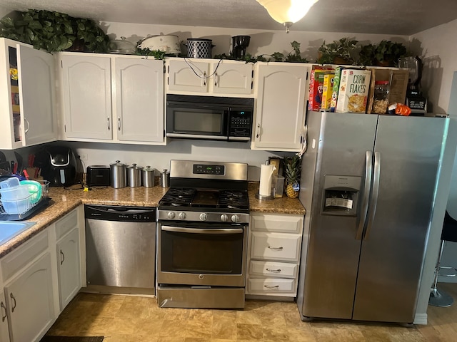 kitchen featuring white cabinetry and stainless steel appliances