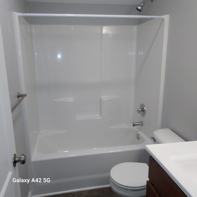 full bath with washtub / shower combination, vanity, and toilet