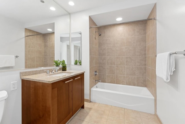 full bathroom featuring vanity, tiled shower / bath combo, tile patterned floors, and toilet