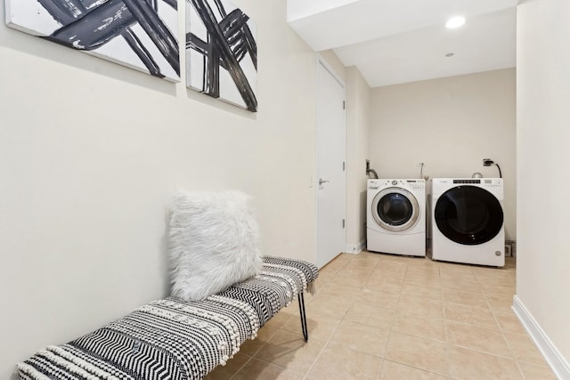 laundry room featuring light tile patterned flooring and washing machine and dryer