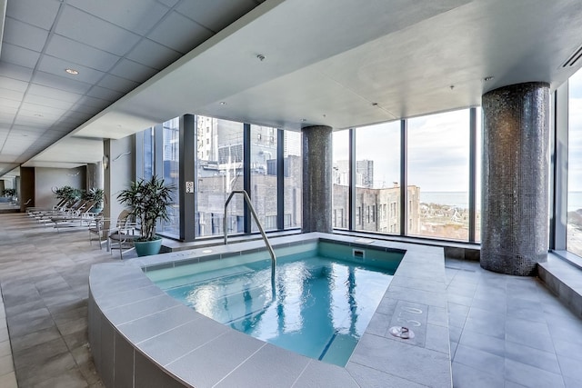 view of pool with an indoor hot tub