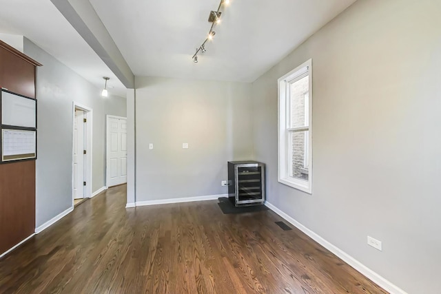 interior space featuring beverage cooler and dark hardwood / wood-style floors