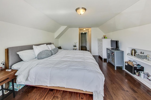 bedroom featuring dark wood-type flooring and vaulted ceiling