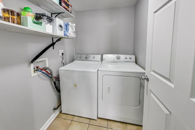 laundry area featuring light tile patterned floors and independent washer and dryer