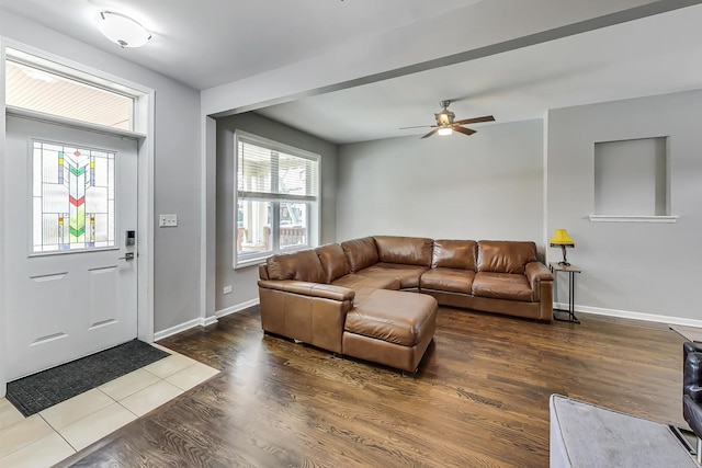 living room featuring dark wood-type flooring and ceiling fan