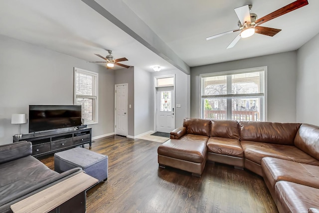 living room with dark wood-type flooring and ceiling fan