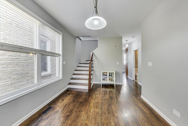 interior space with plenty of natural light and dark hardwood / wood-style floors