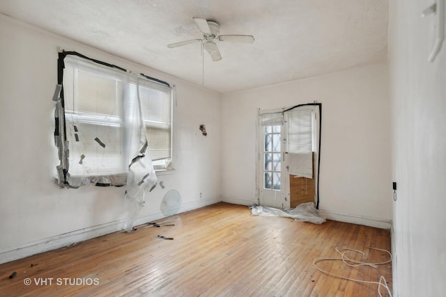 spare room featuring hardwood / wood-style floors, plenty of natural light, and ceiling fan