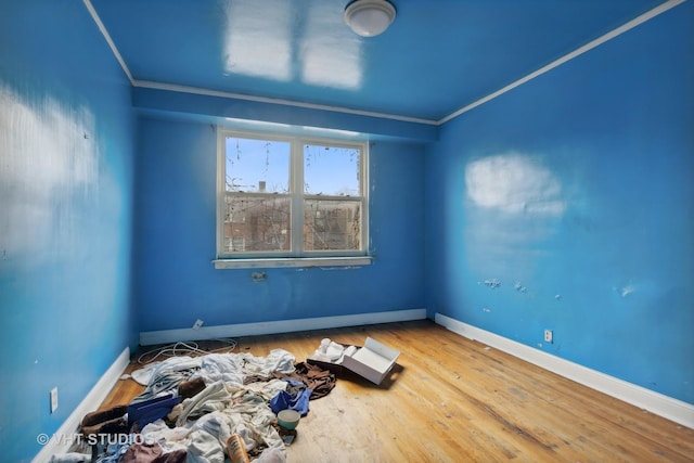 unfurnished room with wood-type flooring and ornamental molding