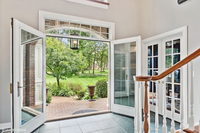 doorway featuring tile patterned flooring and french doors