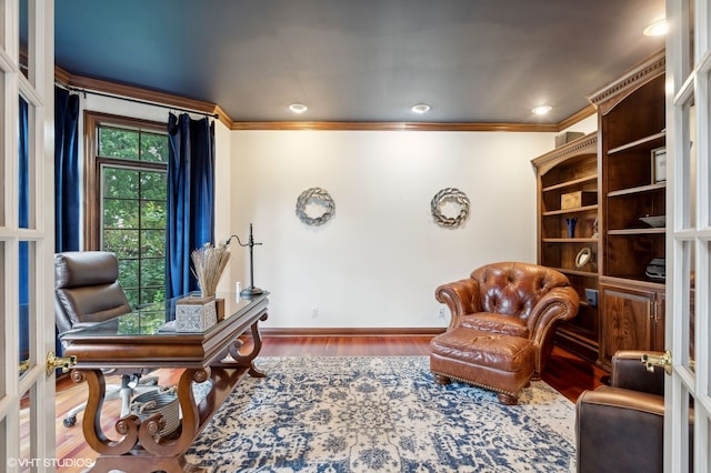 living area featuring crown molding and wood-type flooring