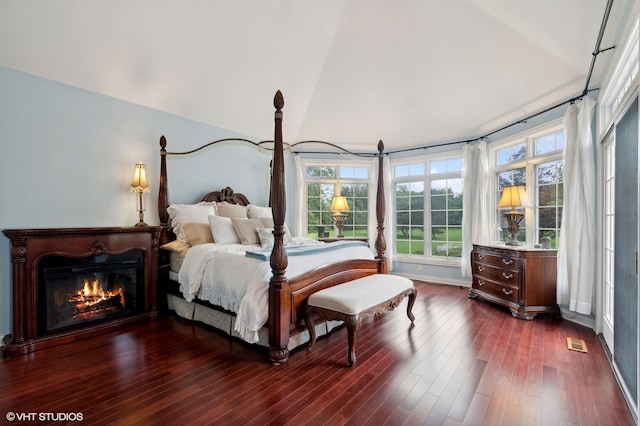 bedroom featuring lofted ceiling and dark hardwood / wood-style floors