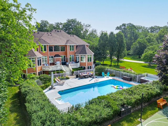 view of swimming pool with a wooden deck, a yard, and a patio