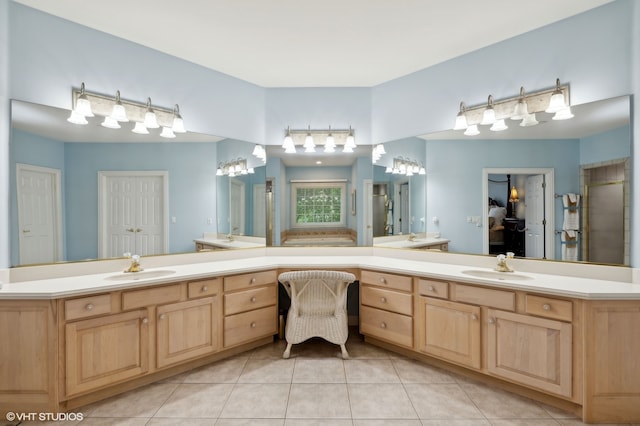 bathroom with tile patterned flooring, a shower with door, and vanity