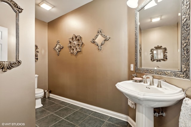 bathroom with toilet and tile patterned floors