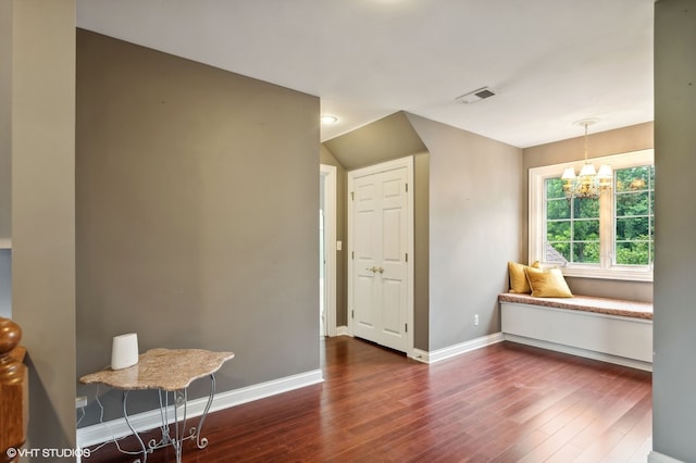 interior space featuring dark hardwood / wood-style floors and a notable chandelier