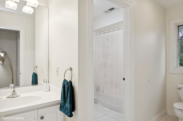 bathroom with tile patterned flooring, vanity, toilet, and walk in shower