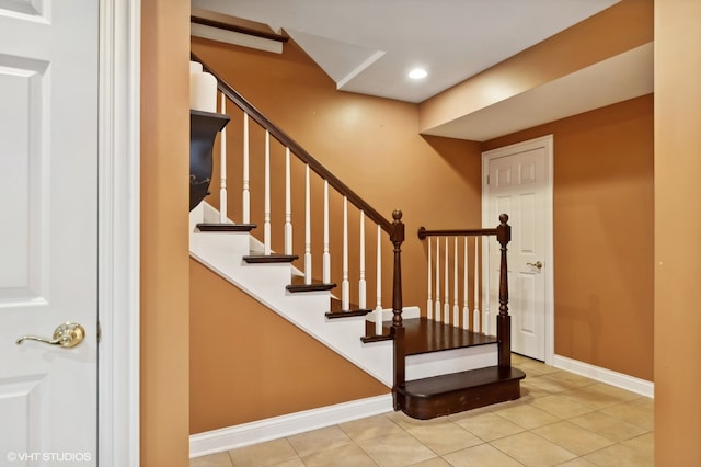 staircase featuring tile patterned flooring