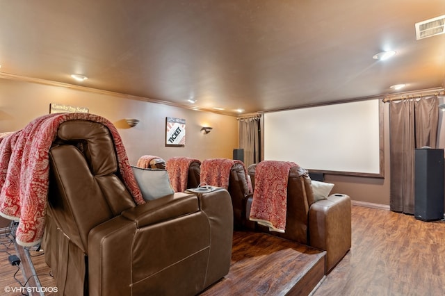 home theater featuring crown molding and hardwood / wood-style flooring