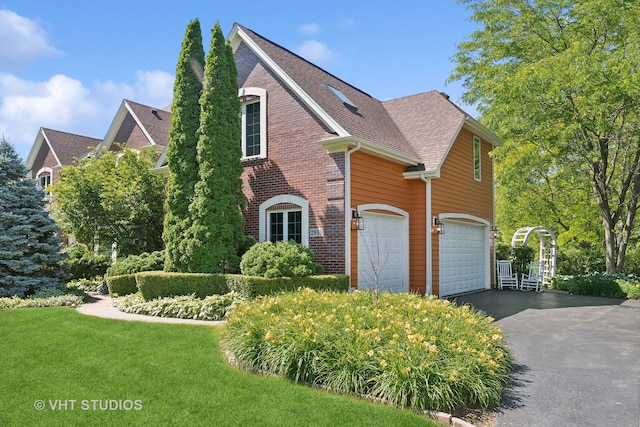 front facade with a front yard and a garage