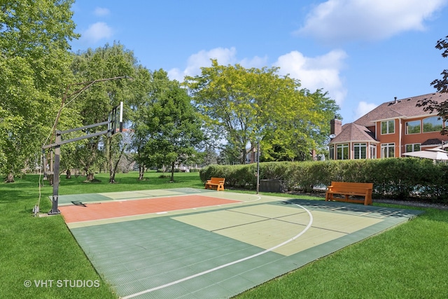 view of sport court featuring a lawn