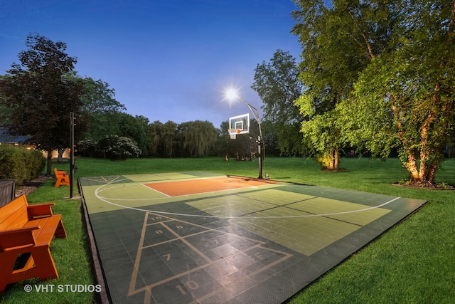 view of sport court featuring a yard