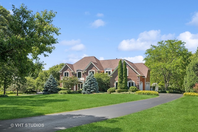 view of front of home with a garage and a front lawn