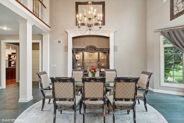 dining space featuring decorative columns, plenty of natural light, and a notable chandelier