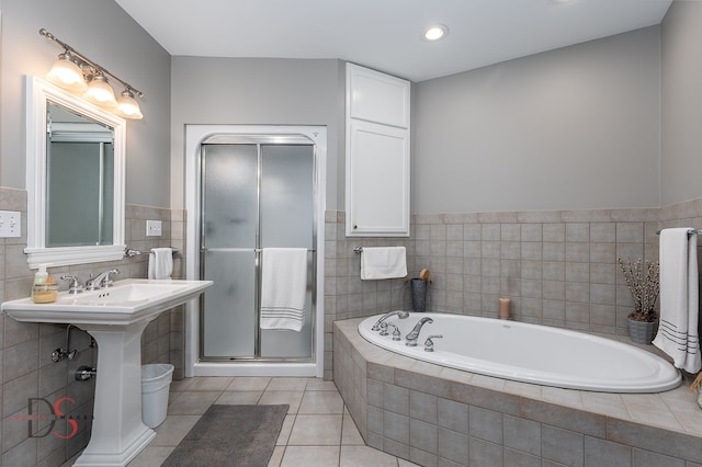 bathroom featuring tile walls, tile floors, and plus walk in shower