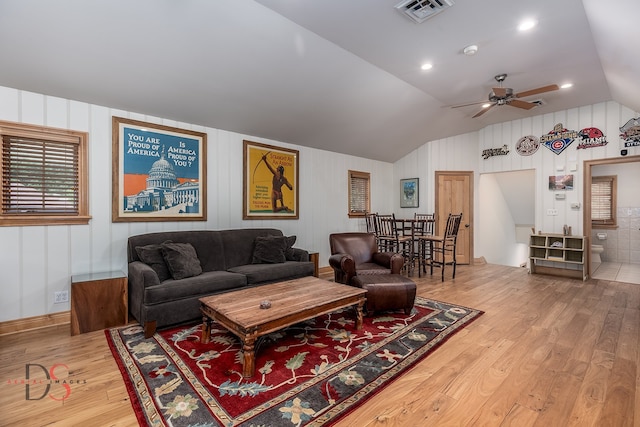 living room featuring ceiling fan, light hardwood / wood-style flooring, and lofted ceiling